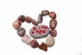 I love you on a pebble, surrounded by a heart of pebbles