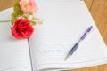 I love you text in notebook with pen and fake flower Royalty Free Stock Photo