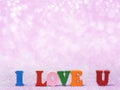 I LOVE YOU text on pink abstract glitter background with bokeh. lights blurry soft pink for the romance background and background