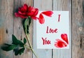 I Love you text on sheet of paper, red peony on old rustic wooden background Royalty Free Stock Photo
