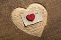 I love you - tiny typed text note close up. Valentines Day greetings concept. Carved heart shape on wood as background Royalty Free Stock Photo