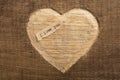 I love you - tiny typed text note close up. Valentines Day greetings concept. Carved heart shape on wood as background for Royalty Free Stock Photo