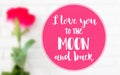 I love you to the moon and back words on blurred image of red rose white floor background.