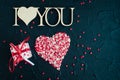 I Love You - wooden phrase on black stone background