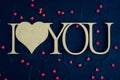 I Love You - wooden phrase on black stone background