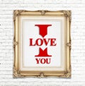 I love you word in golden vintage photo frame on white brick wall,Love concept Royalty Free Stock Photo