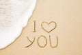 I love you written on wet yellow beach sand Royalty Free Stock Photo