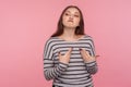 I`m the best! Portrait of arrogant egoistic woman in striped sweatshirt pointing herself and looking supercilious selfish