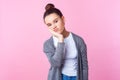 I`m bored. Portrait of depressed brunette teenage girl leaning on head, looking tedious tired of everything. pink background