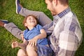 I'm the luckiest dad ever. a father and son playing on the grass together.