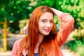 I`m sexy and I know it. Red head girl posing hand on head looking at you camera isolated Green trees Park Background outdoors Royalty Free Stock Photo