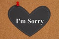 Iâm sorry message on chalkboard heart on a corkboard Royalty Free Stock Photo