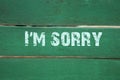 I`m sorry- phrase written on old green background