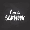 I`m a survivor - hand drawn October Breast Cancer Awareness Month lettering phrase on black chalkboard background. Brush Royalty Free Stock Photo