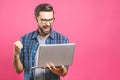 I`m a winner! Happy man holding laptop and celebrating his success over pink background Royalty Free Stock Photo