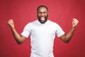 I`m winner. Portrait of happy african american man isolated over red background