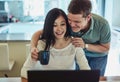 I made you coffee to inspire you for your blog. a young couple using a laptop together. Royalty Free Stock Photo