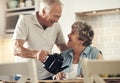 I made you some tea. a senior couple having breakfast together at home. Royalty Free Stock Photo