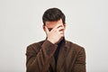 I messed up. Young man covering his eyes with hand in shame isolated on a white background