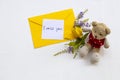 I miss you message card handwriting with yellow envelope, yellow flower ylang ylang and teddy bear Royalty Free Stock Photo