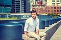 Young man sitting outdoors in New York City Royalty Free Stock Photo