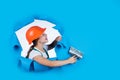 I need help. kid wear helmet on construction site. teen girl plasterer with tool spatula. child on repairing work Royalty Free Stock Photo