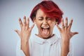 I need a manicure right now. Studio shot of an attractive young woman screaming against a gray background. Royalty Free Stock Photo