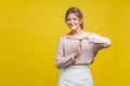 I need more time. Portrait of tired upset young woman with fair hair in casual beige blouse, isolated on yellow background