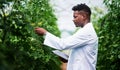 I need to do more research regarding this plant. a handsome young botanist using a digital tablet while working outdoors Royalty Free Stock Photo