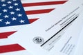 I-360 Petition for Amerasian, Widower or special immigrant blank form lies on United States flag with envelope from Department of