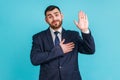 I promise to tell truth! Bearded man wearing official style suit standing raising hand and saying swear, making loyalty oath, Royalty Free Stock Photo