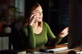 I put in the extra hours for my clients. a woman talking on her cellphone while working late at the office. Royalty Free Stock Photo