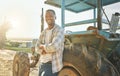 I put in the hard labour. a young farmer standing next to a tractor outside. Royalty Free Stock Photo