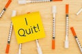 I quit message with disposable vaccine needle on desk with a sticky note