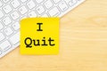 I quit message on keyboard with a blank sticky note on a desk