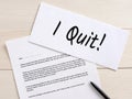 I quit message written on an envelope with a resignation letter on an office desktop Royalty Free Stock Photo