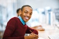 I am so ready for this exam. a cheerful young man making notes while being seated in a library and looking at the camera Royalty Free Stock Photo