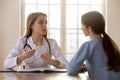 Tactful confident millennial female physician receiving consulting young woman patient Royalty Free Stock Photo