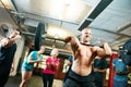 I refuse to just be average. a man lifting weights while a group of people in the background watch on. Royalty Free Stock Photo