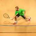 The one jumping player, caucasian fit man, playing tennis on the earthen court