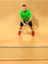 The one jumping player, caucasian fit man, playing tennis on the earthen court