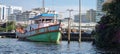 An old fishing boat moored in a canal in Bangkok, Thailand