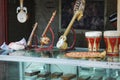 There are several beautiful handmade minority musical instruments on the glass display cabinet