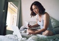 I should write some of these blog ideas down. Full length shot of an attractive young woman writing in a notebook while Royalty Free Stock Photo