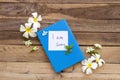 I am sorry message card handwriting on blue diary book with white flowers frangipani ,jasmine