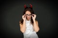 I only spook when spoken to. Sexy woman wear Halloween red devil horns and eyeglasses. Sensual girl dressed for