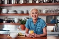 I always start my day with a glass of orange juice. Cropped portrait of an attractive senior woman enjoying a glass of Royalty Free Stock Photo