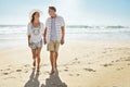 I still fall more in love with you each day. a mature couple walking along the beach. Royalty Free Stock Photo
