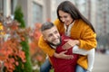 Delighted well built young man carrying his girlfriend Royalty Free Stock Photo