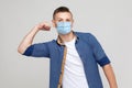 I am strong. Portrait of haughty young man in casual style with surgical medical mask standing with raised arms and looking at